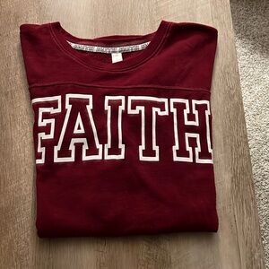 Burgundy Sweatshirt with the words FAITH on the front written in white Size M